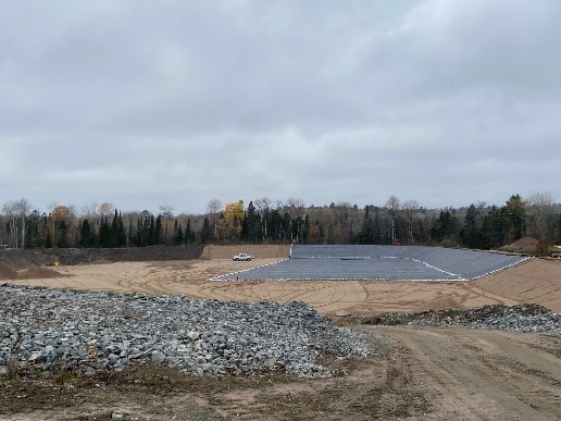 More rock was overtopped with sand to protect the geomembrane