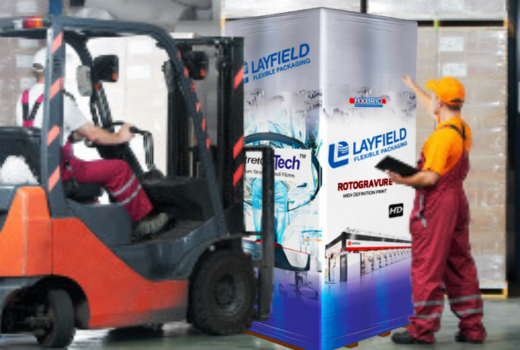 Forklift driver transporting shrink-wrapped pallet with branded Layfield packaging