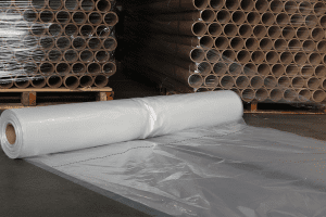 Large industrial roll of clear perforated plastic film used for packaging and protective applications.