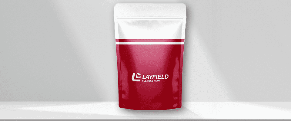 Red and white stand-up pouch with zipper closure featuring the Layfield Flexible Films logo, displayed on a minimal white background.