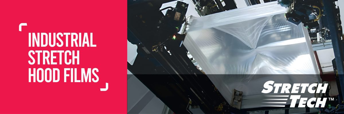 Industrial stretch hood film being applied by automated machinery for palletized load containment.