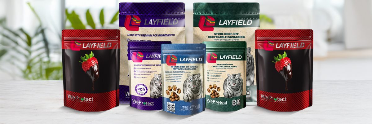 A selection of Layfield's food packaging solutions in various sizes and designs, displayed on a white surface with a blurred kitchen background.